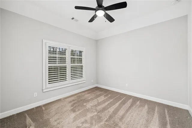 a view of a hallway with wooden floor and a bathroom view