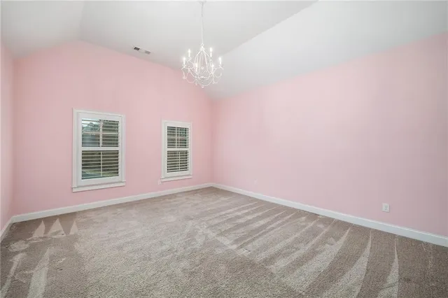 a view of a house with a big yard and a large tree