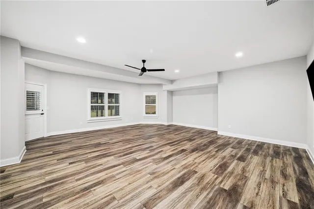 a view of a house with potted plants and a barbeque