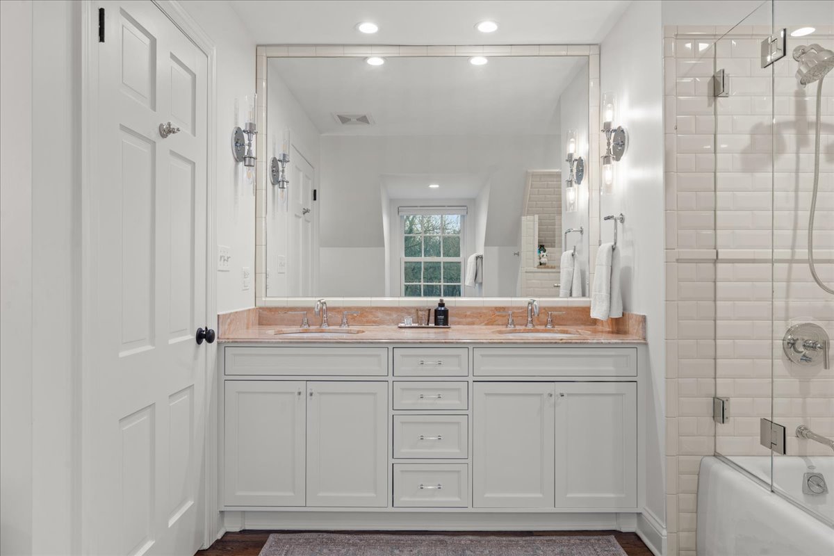 2335 Pebblefork Lane Northfield, IL 60093 - Photo 55 of 92 a bathroom with a granite countertop sink a mirror and a shower