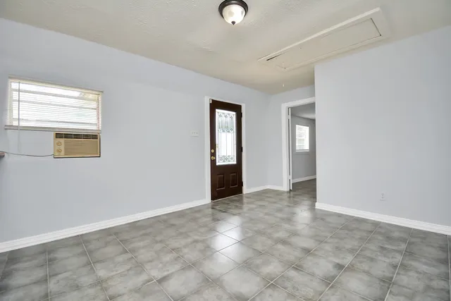 an empty room with windows and closet