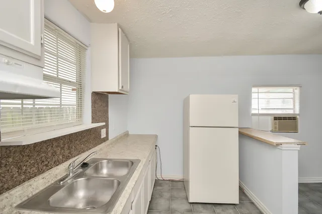 a kitchen with cabinets and white appliances