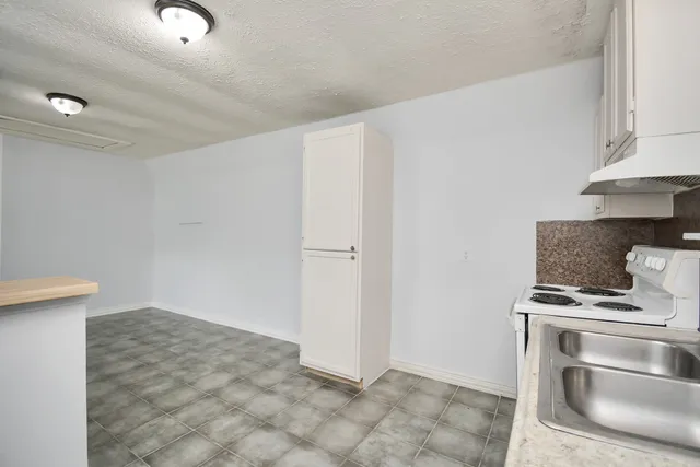 a kitchen with cabinets appliances and a window