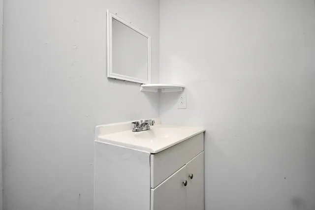 a bathroom with a sink a vanity and a window