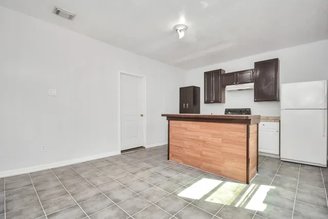 a kitchen with granite countertop a sink cabinets and stainless steel appliances