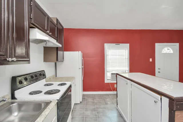 a kitchen with a stove and a refrigerator