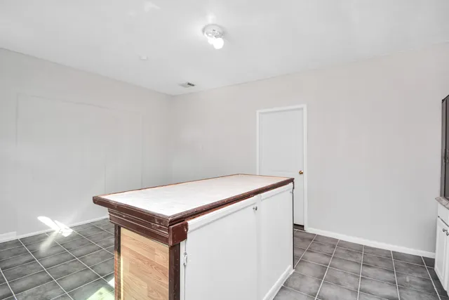 a kitchen with a refrigerator and a stove