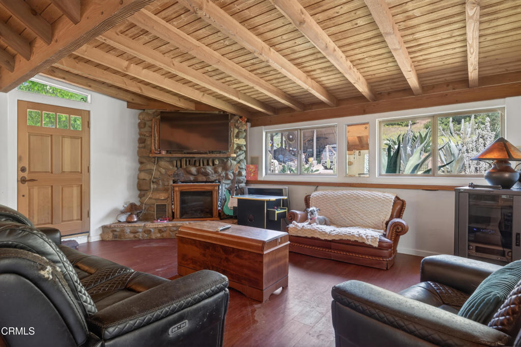 8416 Wheeler Canyon Road Santa Paula, CA 93060 - Photo 9 of 48 a living room with furniture a fireplace and a large window