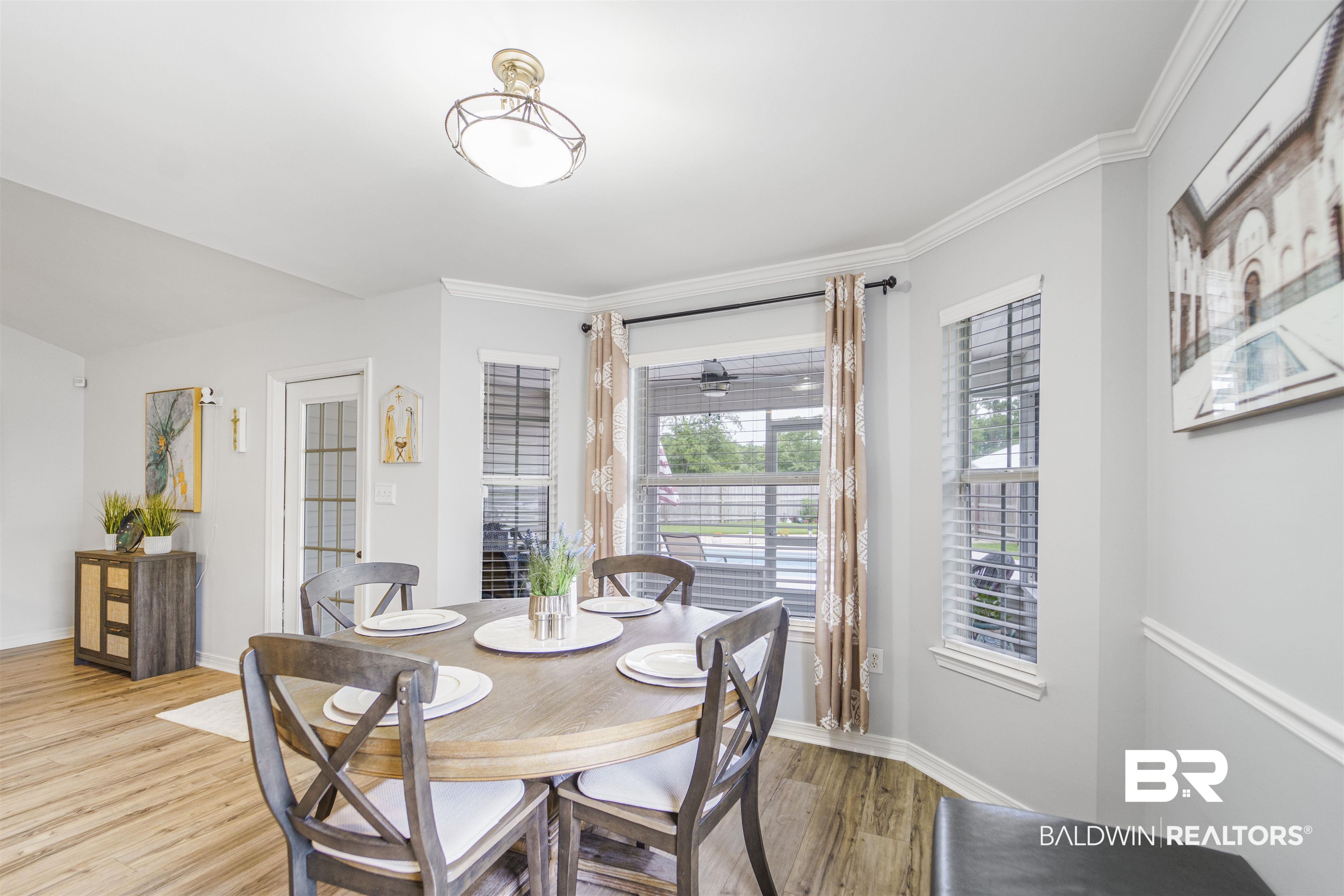 4620 Pine Boulevard Orange Beach, AL 36561 - Photo 13 of 49 Dining area featuring light wood-type flooring and crown molding