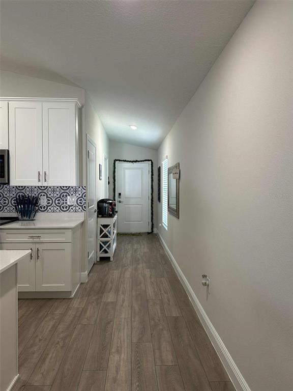 6245 Southwest 96th Place Ocala, FL 34476 - Photo 15 of 38 a kitchen with sink cabinets and wooden floor