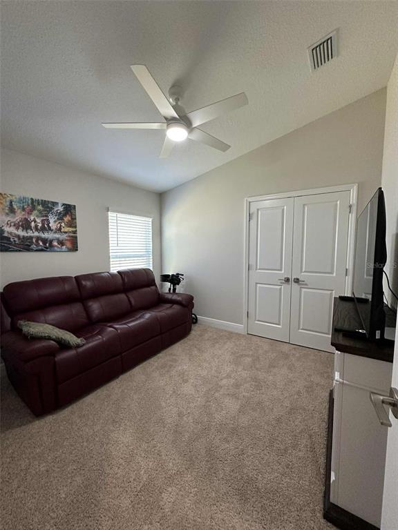 6245 Southwest 96th Place Ocala, FL 34476 - Photo 16 of 38 a living room with furniture a ceiling fan and a window