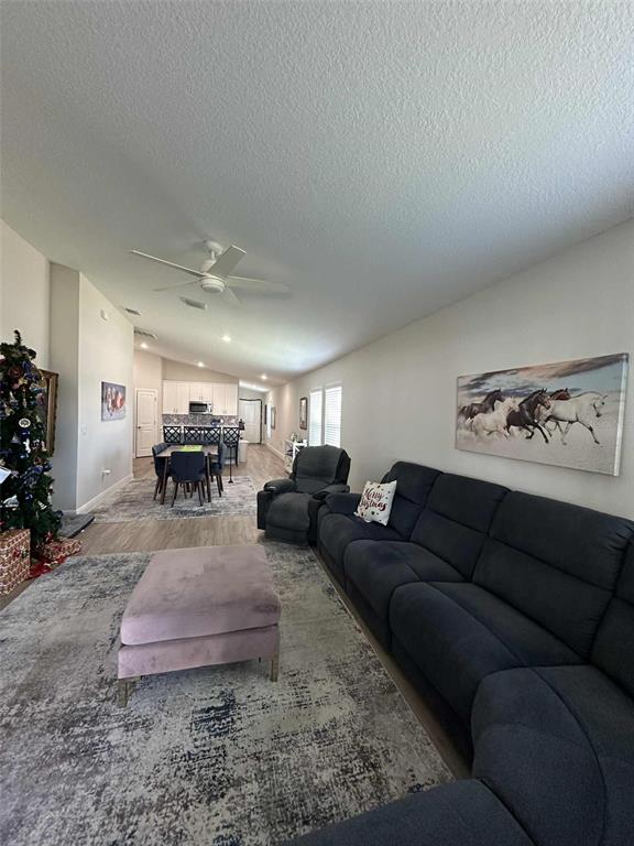 6245 Southwest 96th Place Ocala, FL 34476 - Photo 22 of 38 a living room with furniture and a chandelier