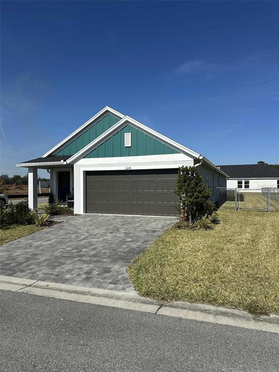 6245 Southwest 96th Place Ocala, FL 34476 - Photo 4 of 38 a front view of a house with a yard