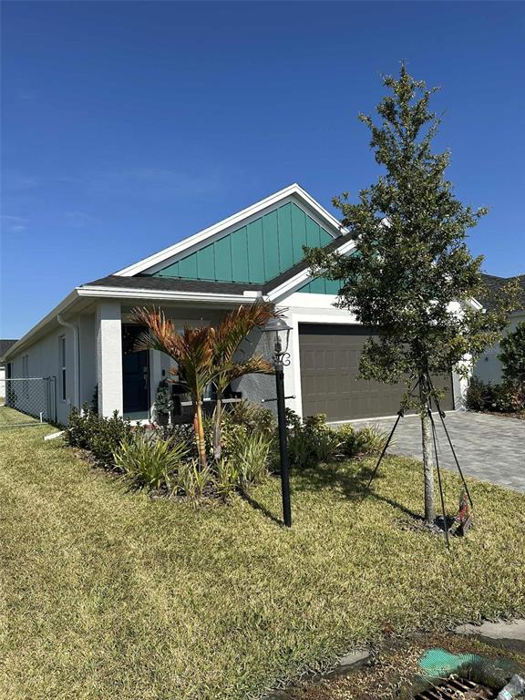 6245 Southwest 96th Place Ocala, FL 34476 - Photo 5 of 38 a backyard of a house with table and chairs under an umbrella