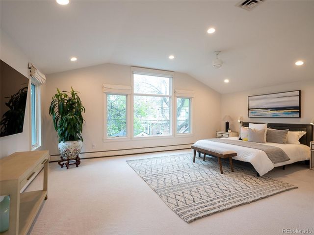 a living room with furniture rug and flat screen tv