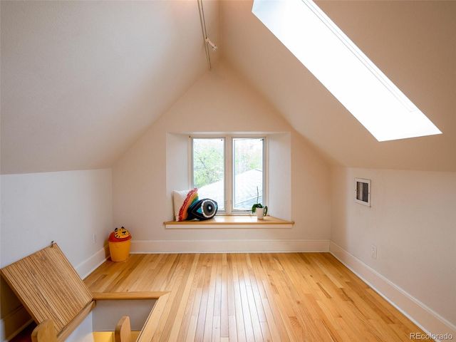 a view of a room with window and wooden floor