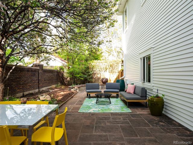 a view of a patio with table and chairs and potted plants