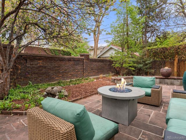 a view of a backyard with sitting area and furniture