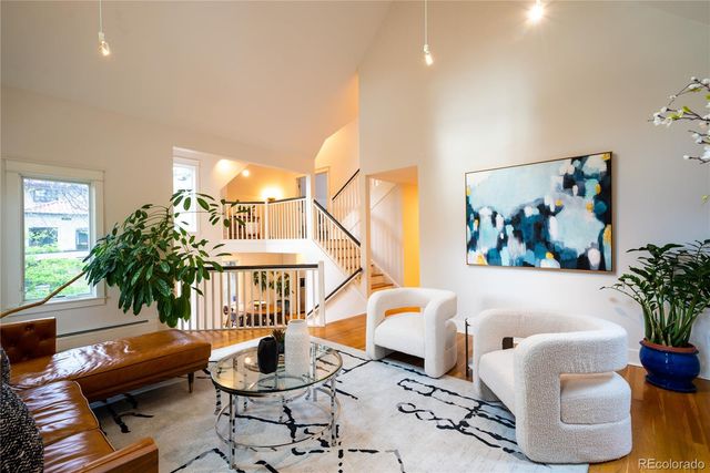 a living room with furniture and a potted plant