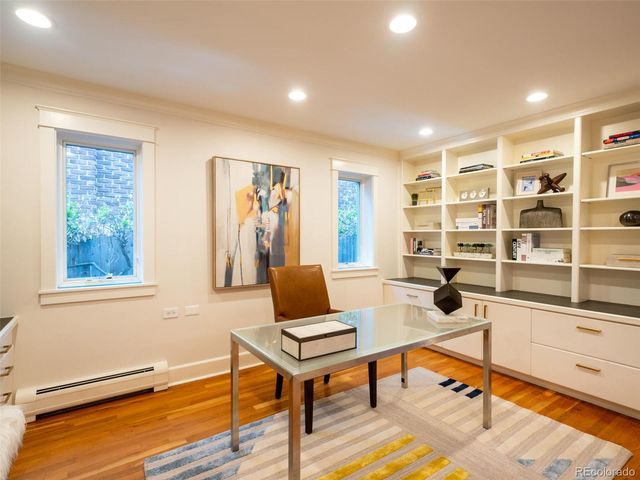 a living room with furniture a rug and a window