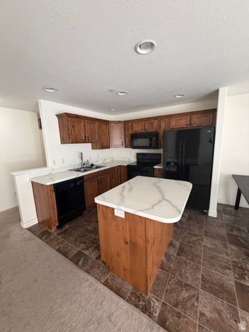 909 South Main Street, Unit F Layton, UT 84041 - Photo 2 of 20 Kitchen featuring wood cabinetry, black appliances, a central island with a white countertop, and recessed lighting