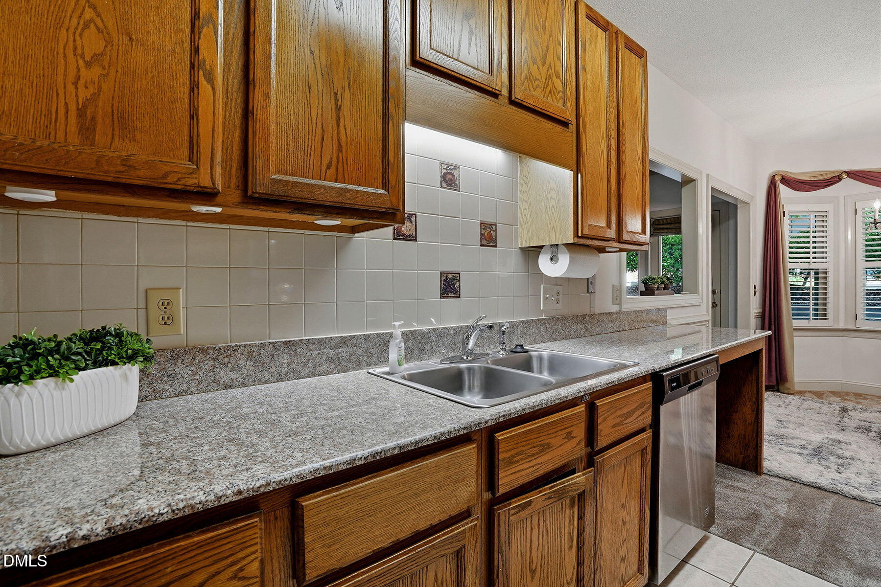 1210 Shadow Bark Court Raleigh, NC 27603 - Photo 18 of 29 a kitchen with granite countertop stainless steel appliances a sink and cabinets