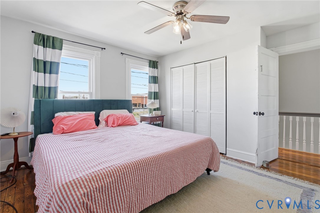 1602 Decatur Street Richmond, VA 23224 - Photo 19 of 25 a bedroom with a large bed and a chandelier