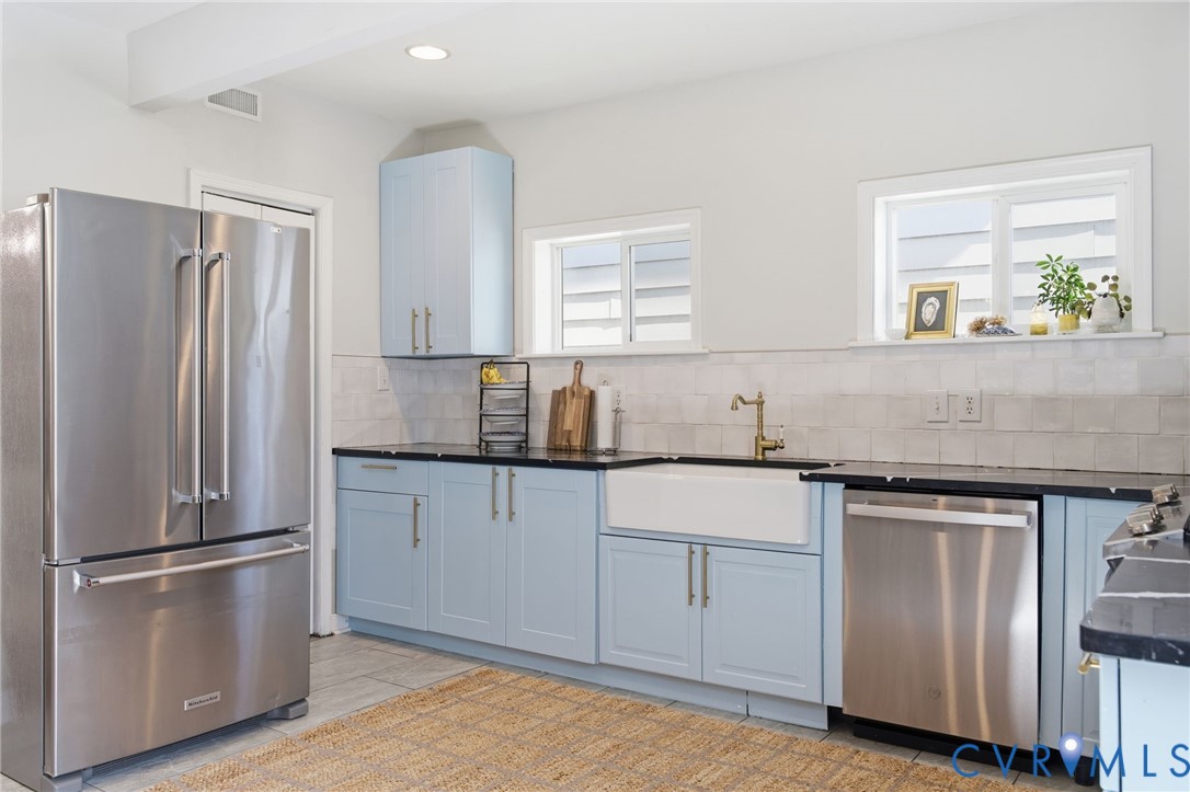 1602 Decatur Street Richmond, VA 23224 - Photo 3 of 25 a kitchen with stainless steel appliances granite countertop a refrigerator a sink and white cabinets
