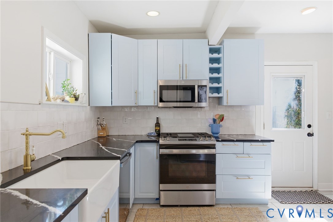 1602 Decatur Street Richmond, VA 23224 - Photo 5 of 25 a kitchen with a sink stove and microwave