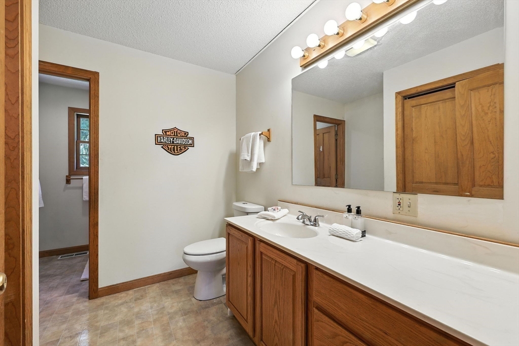 285 Lower Hampden Road Monson, MA 01057 - Photo 16 of 40 a bathroom with a double vanity sink and a mirror