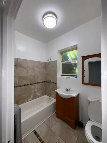 a bathroom with a sink a toilet and bathtub
