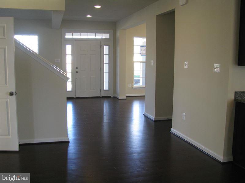 7207 Maisson Ridge Circle Beltsville, MD 20705 - Photo 2 of 5 a view of a room with wooden floor and window