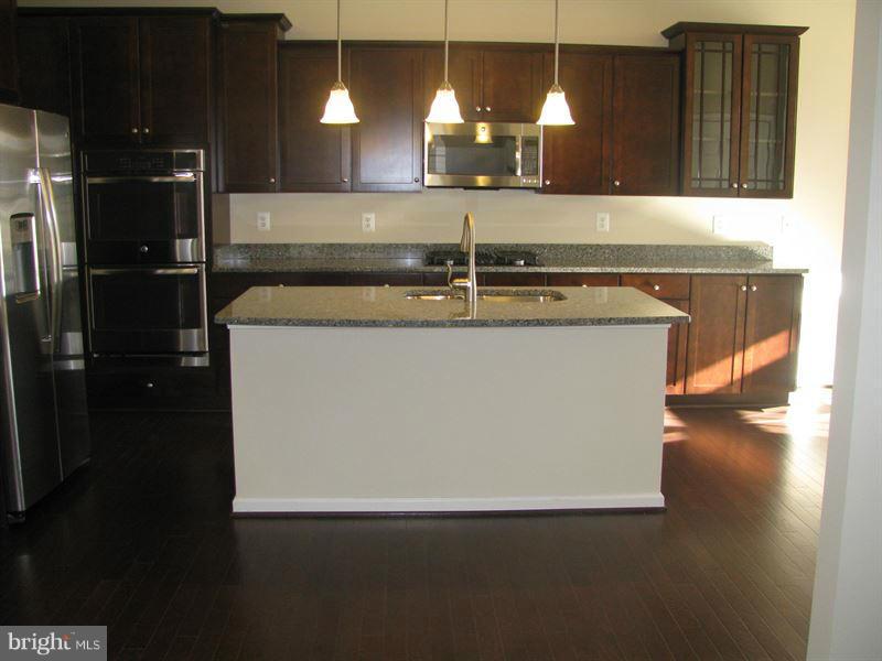 7207 Maisson Ridge Circle Beltsville, MD 20705 - Photo 3 of 5 a kitchen with stainless steel appliances granite countertop a sink a stove and a refrigerator