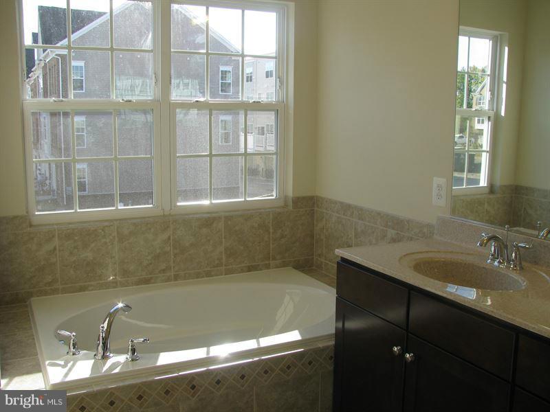 7207 Maisson Ridge Circle Beltsville, MD 20705 - Photo 5 of 5 a bathroom with a granite countertop sink and a bathtub