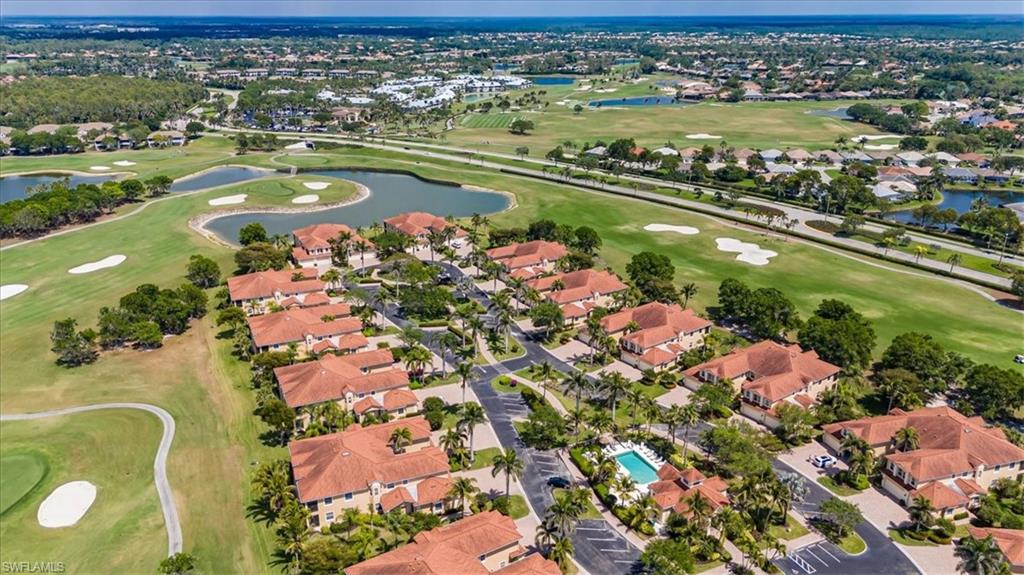 8637 Champions Point, Unit 902 Naples, FL 34113 - Photo 1 of 26 Bird's eye view with view of golf course, a residential view, and a water view