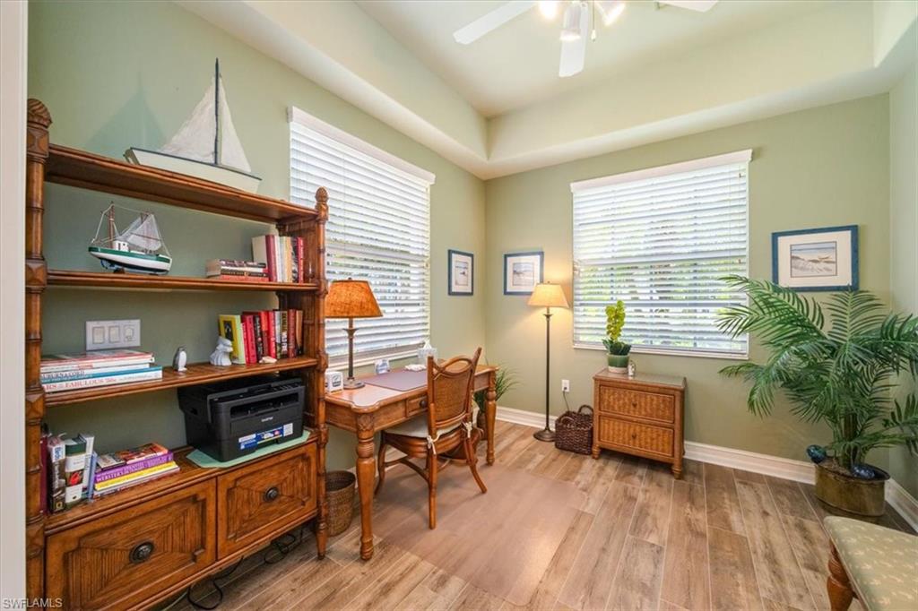 8637 Champions Point, Unit 902 Naples, FL 34113 - Photo 12 of 26 Office area featuring baseboards, light wood-style floors, and ceiling fan