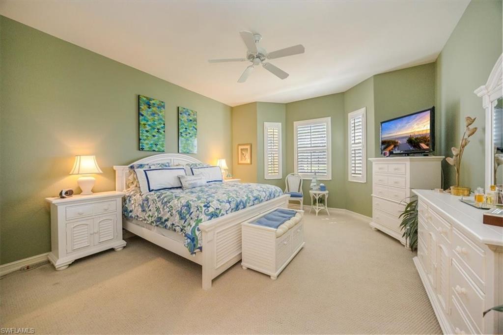 8637 Champions Point, Unit 902 Naples, FL 34113 - Photo 13 of 26 Bedroom with light colored carpet, baseboards, and a ceiling fan