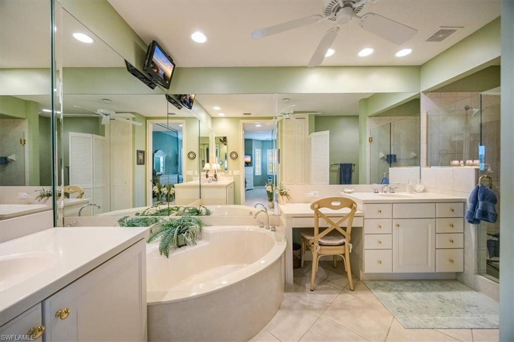 8637 Champions Point, Unit 902 Naples, FL 34113 - Photo 15 of 26 Bathroom featuring tile patterned flooring, a shower stall, visible vents, a ceiling fan, and a bath
