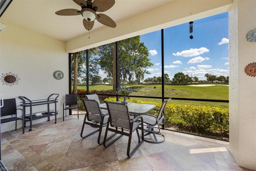 8637 Champions Point, Unit 902 Naples, FL 34113 - Photo 22 of 26 Sunroom featuring a ceiling fan and golf course view