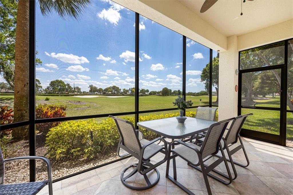 8637 Champions Point, Unit 902 Naples, FL 34113 - Photo 23 of 26 Sunroom with outdoor dining space, view of golf course, and a ceiling fan