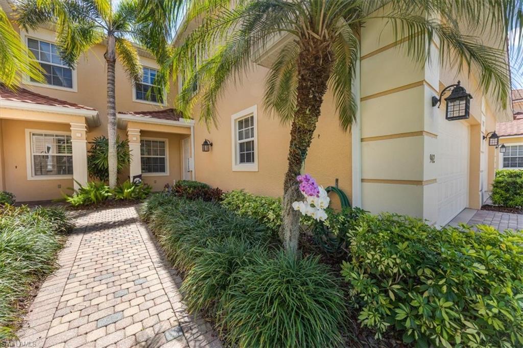 8637 Champions Point, Unit 902 Naples, FL 34113 - Photo 3 of 26 Doorway to property featuring stucco siding