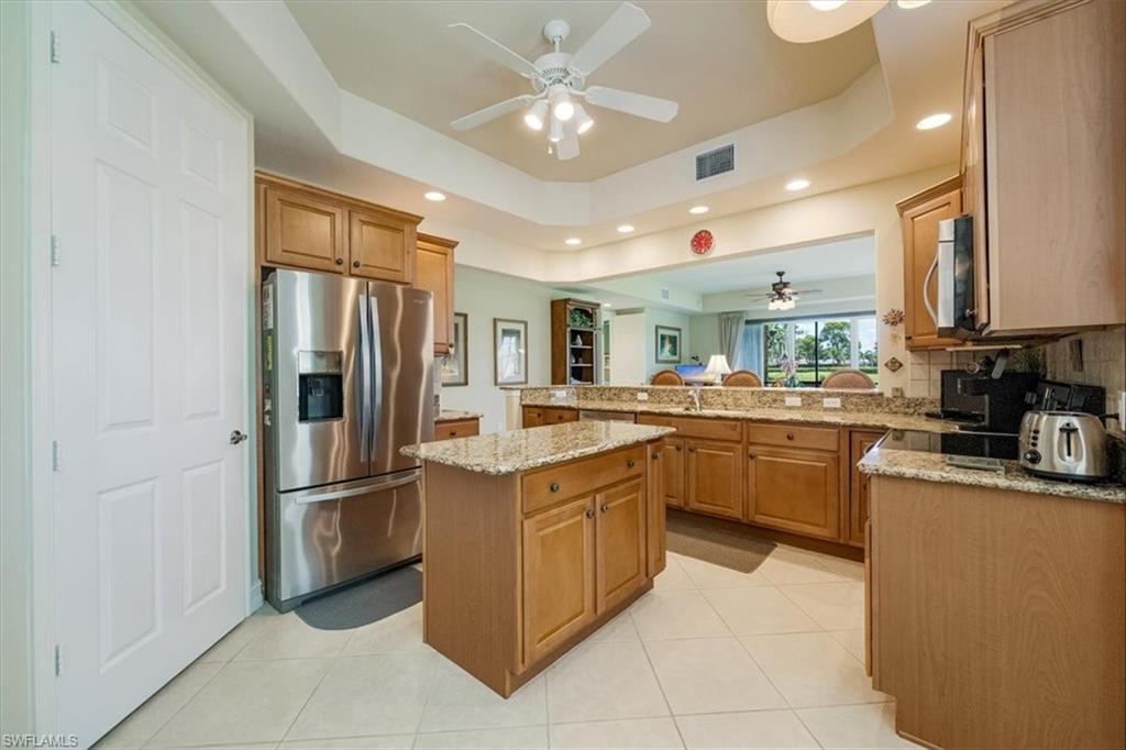 8637 Champions Point, Unit 902 Naples, FL 34113 - Photo 9 of 26 Kitchen featuring a tray ceiling, visible vents, ceiling fan, and appliances with stainless steel finishes