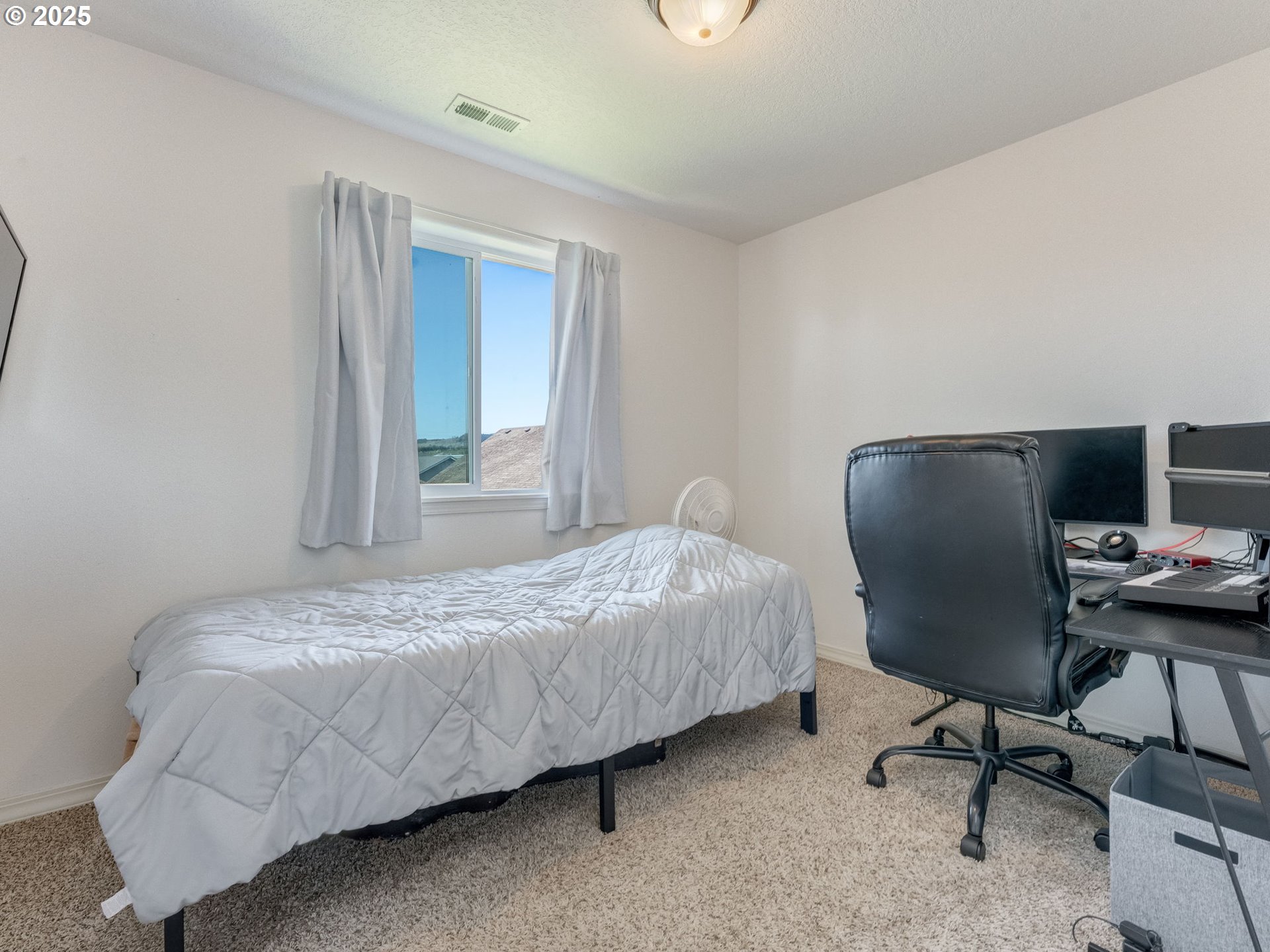 230 Northwest Sagan Loop Sheridan, OR 97378 - Photo 12 of 26 a bedroom with a bed and a chair