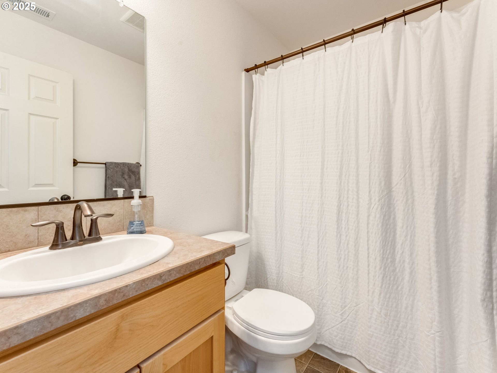 230 Northwest Sagan Loop Sheridan, OR 97378 - Photo 14 of 26 a bathroom with a sink a toilet and shower curtain