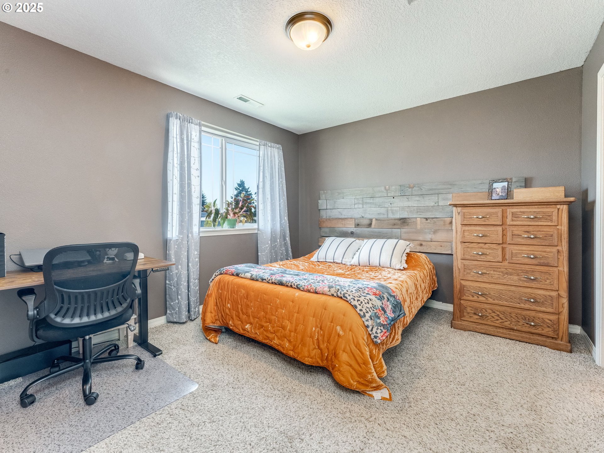 230 Northwest Sagan Loop Sheridan, OR 97378 - Photo 17 of 26 a bedroom with a bed and a chair