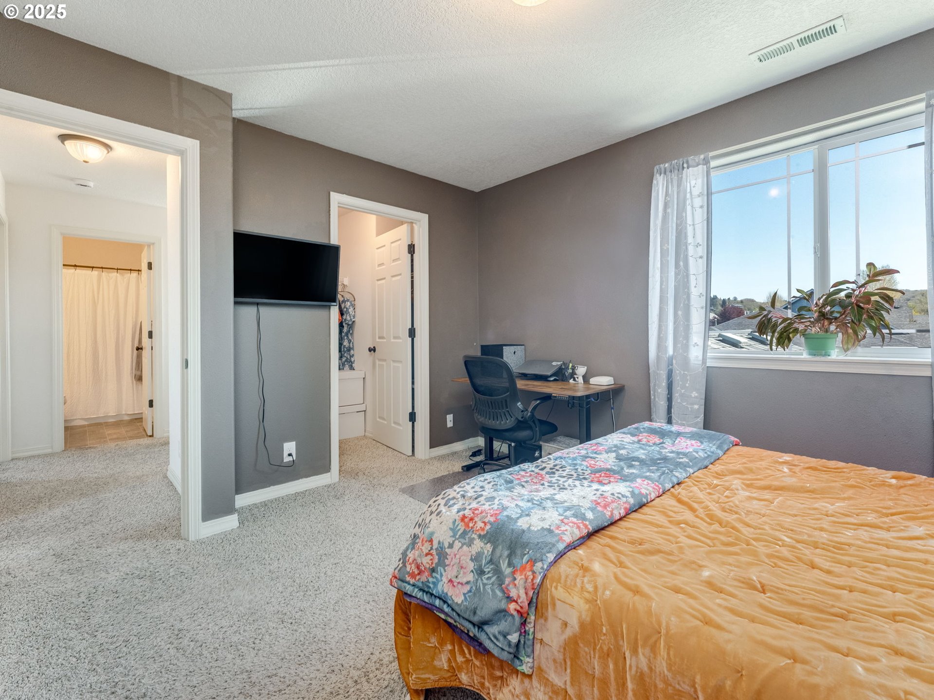 230 Northwest Sagan Loop Sheridan, OR 97378 - Photo 18 of 26 a bedroom with a bed and a flat screen tv