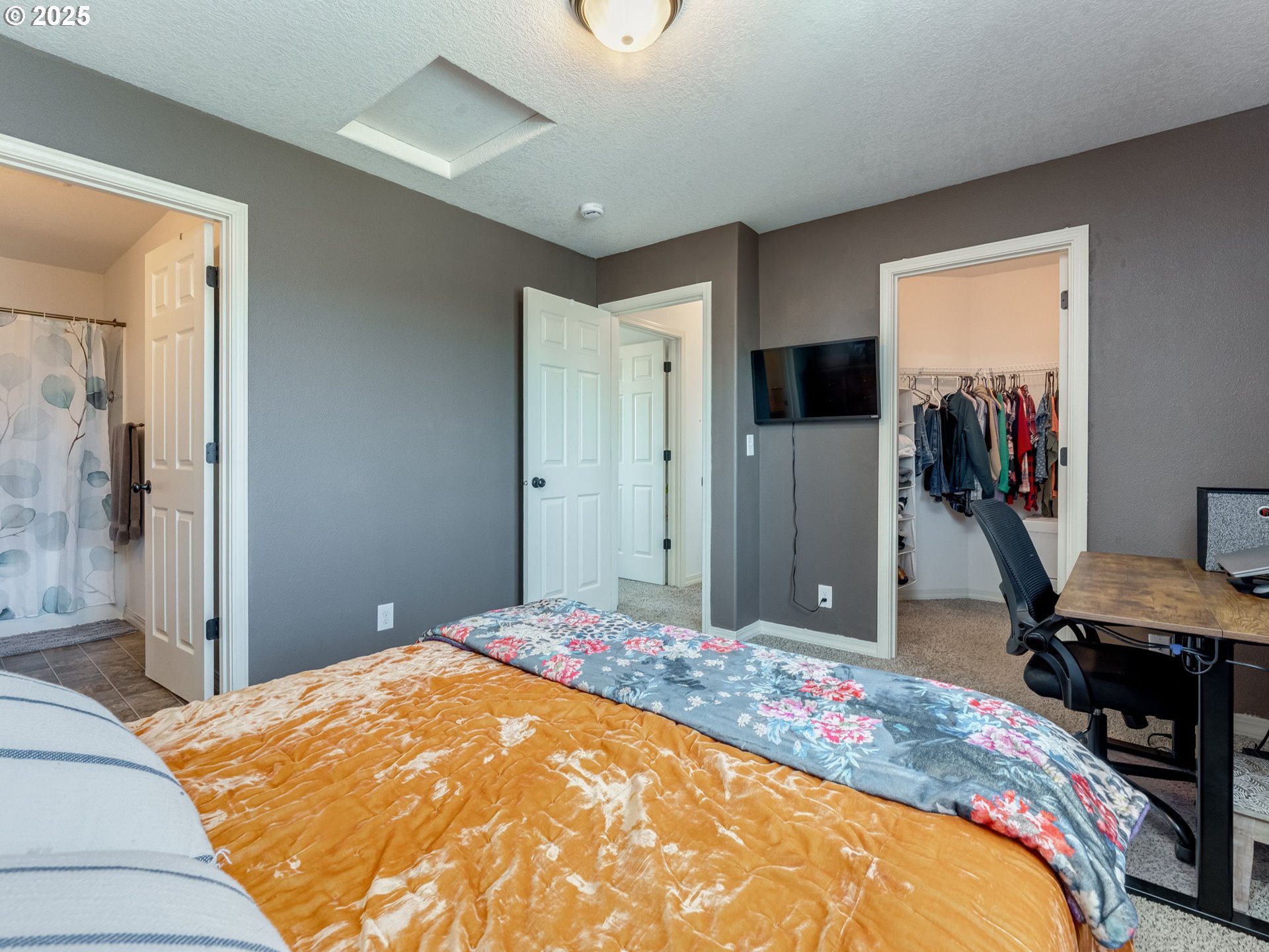 230 Northwest Sagan Loop Sheridan, OR 97378 - Photo 20 of 26 a bedroom with a bed and a flat screen tv