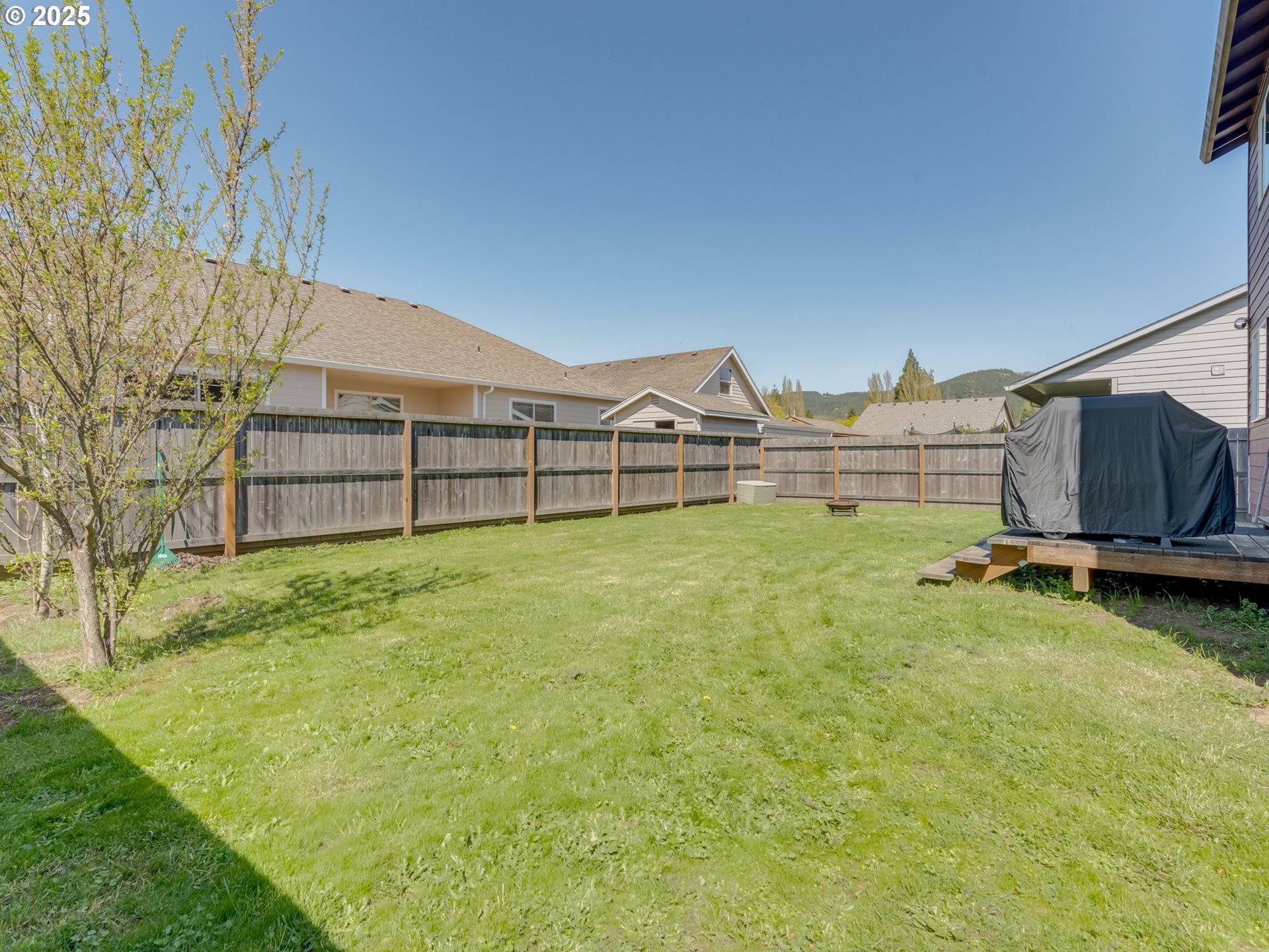 230 Northwest Sagan Loop Sheridan, OR 97378 - Photo 22 of 26 a view of a backyard with a garden and deck