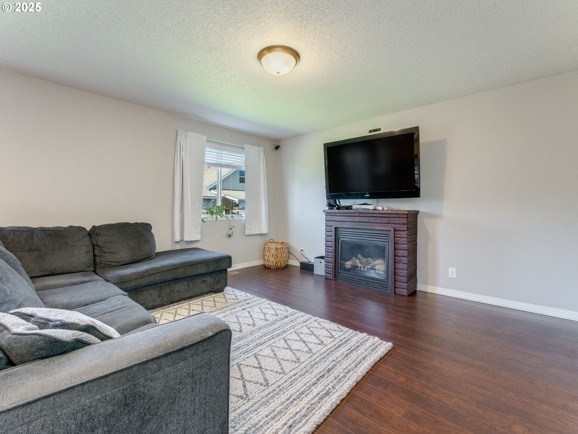 230 Northwest Sagan Loop Sheridan, OR 97378 - Photo 5 of 26 a living room with furniture and a flat screen tv