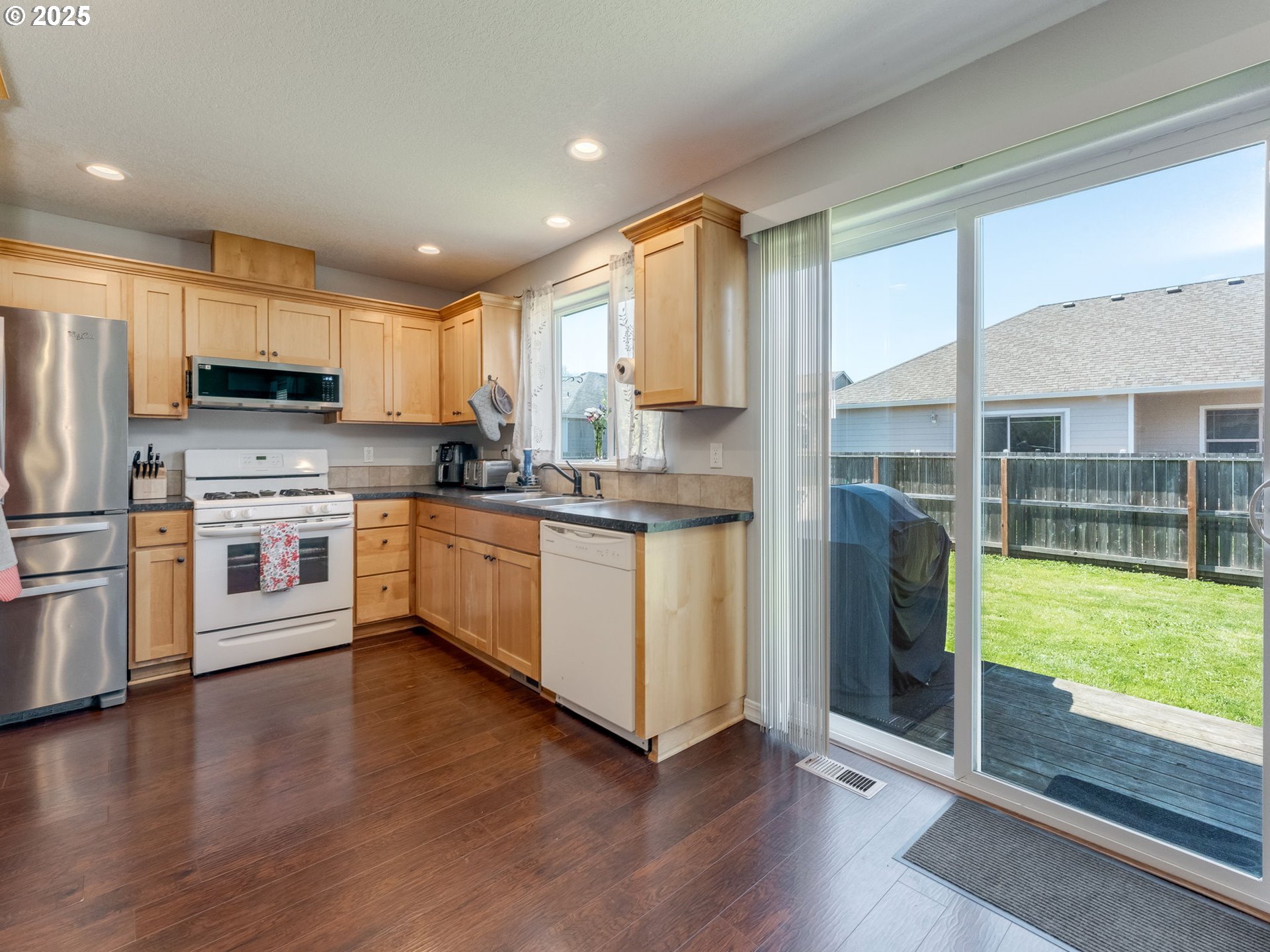 230 Northwest Sagan Loop Sheridan, OR 97378 - Photo 10 of 26 a kitchen with stainless steel appliances granite countertop a stove a sink and a refrigerator